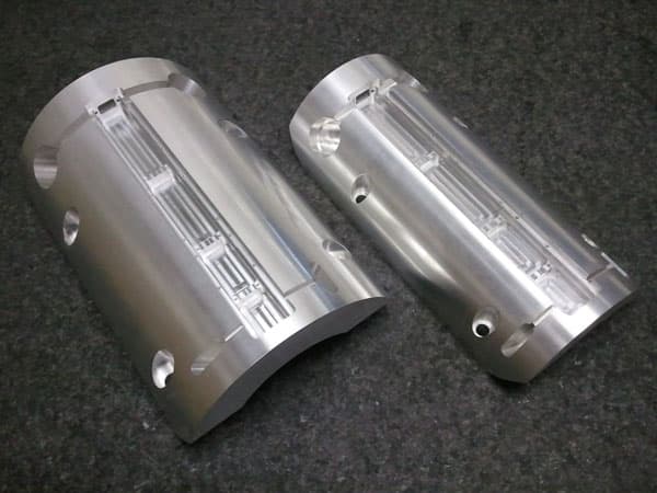 Pair of cylindrical machined aluminum components