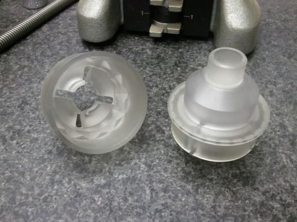 Clear precision-machined components on an inspection surface